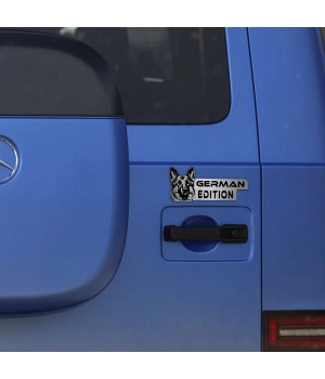 Αυτοκόλλητο German Edition σε μεταλλικό φινίρισμα, με κεφαλή Γερμανικού Ποιμενικού, τοποθετημένο στην πόρτα ενός μπλε οχήματος.